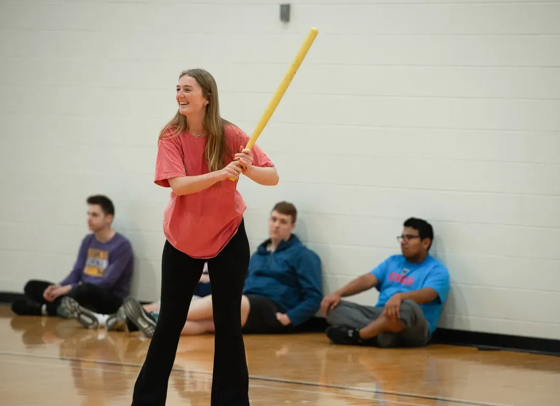 Students playing an intramural wiffleball game.