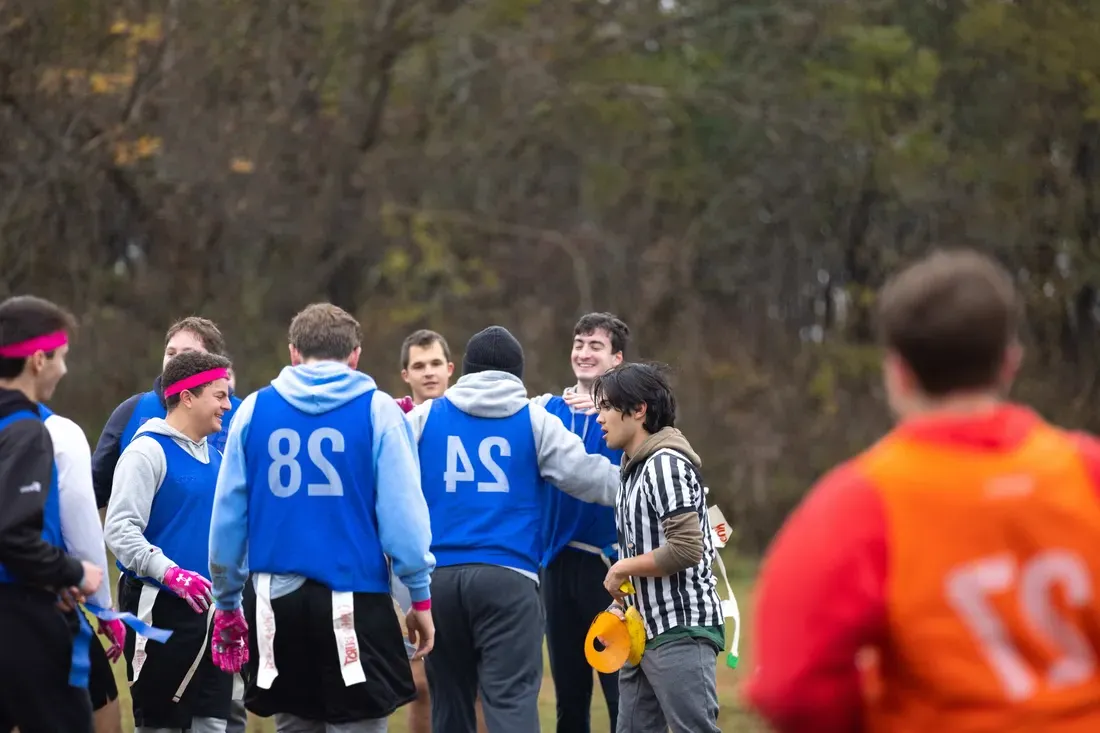 Flag football team gathering together.