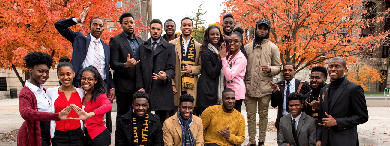 Greek life students pose for a group photo at the Orange Grove in autumn.